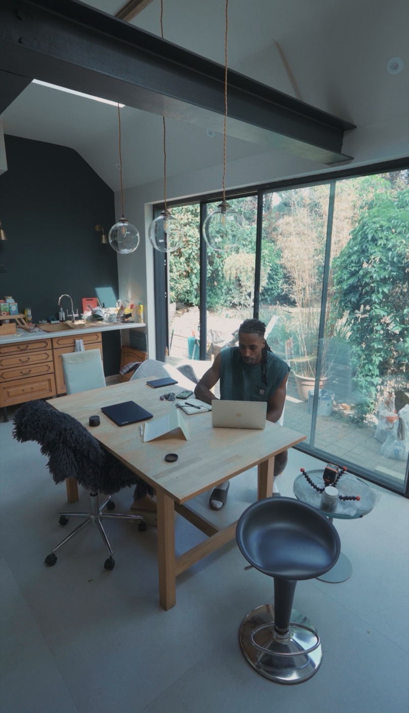 Reece working at a desk in a bright studio